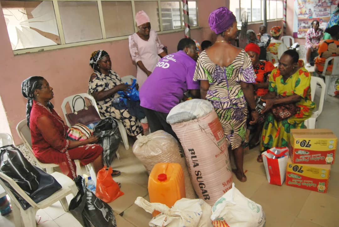 Women gathered with bags and bulk food supplies