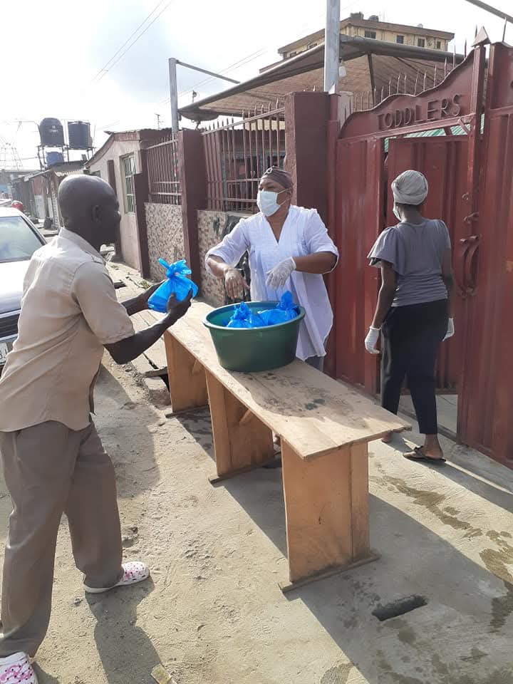 Volunteers distributing prepared food packages during a community outreach