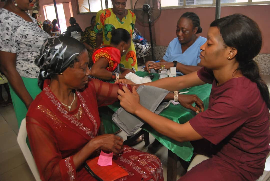 A community member receiving a blood pressure check