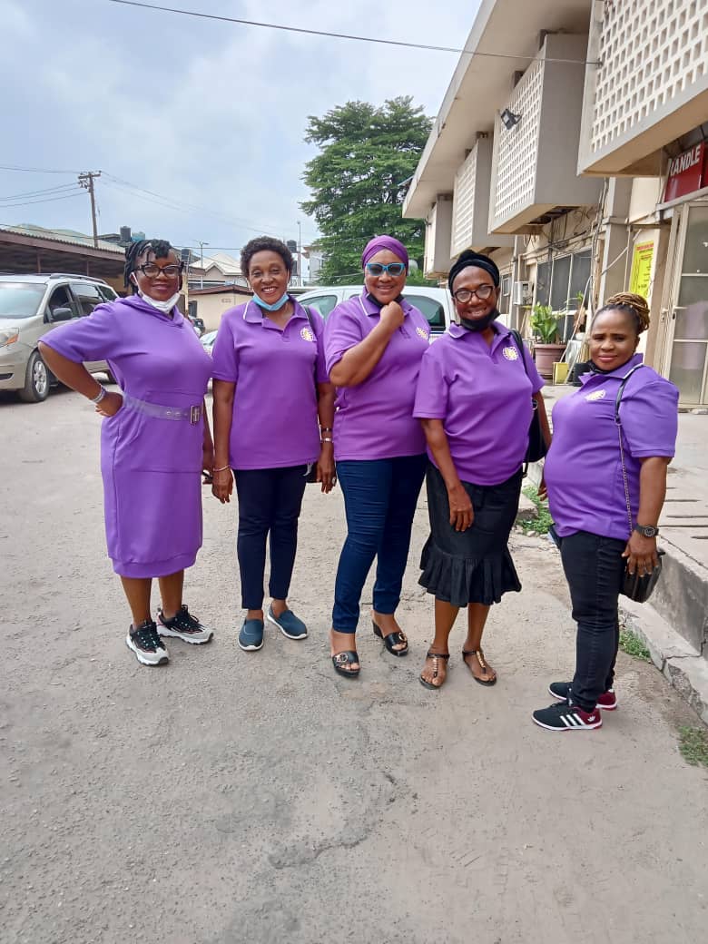 60 Minutes with God members standing together in purple ministry shirts