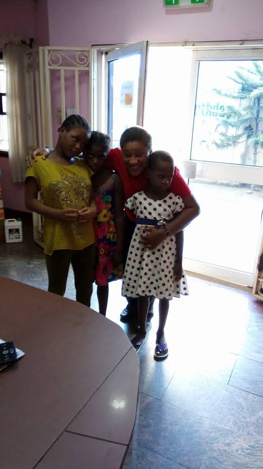 A ministry volunteer embracing children during an orphanage visit